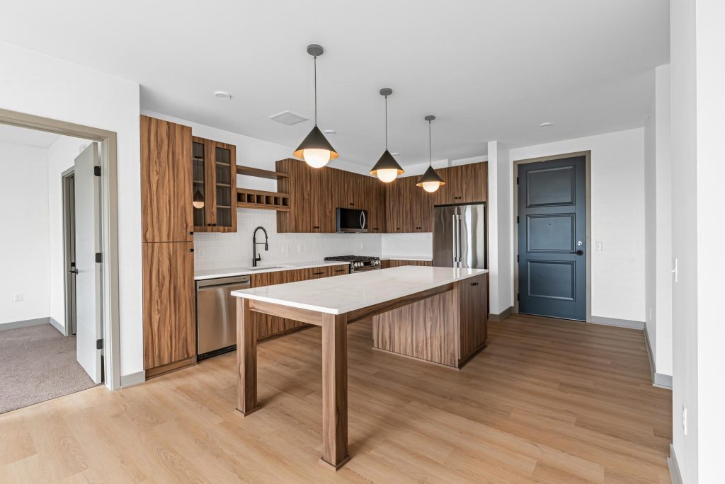 Kitchen with island, wood cabinetry, and pendant lights