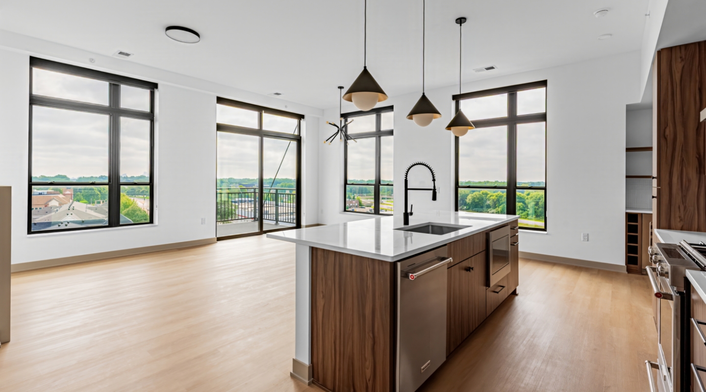 Modern kitchen with island, pendant lights, and large windows