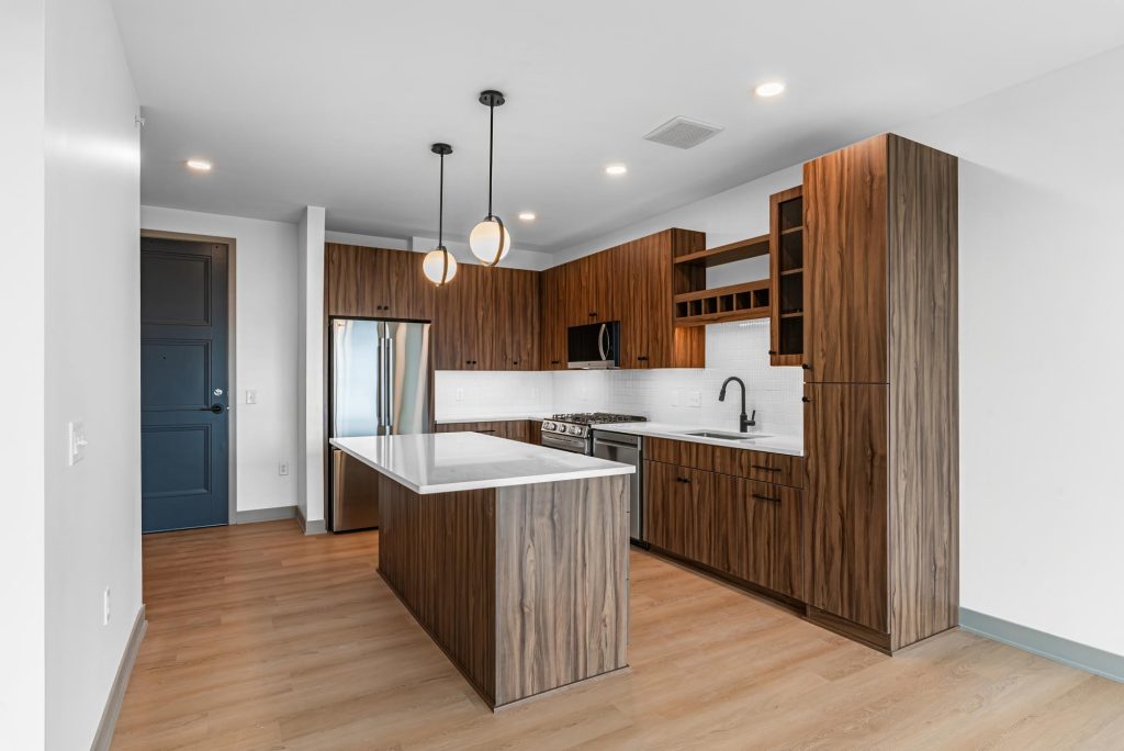 Modern kitchen with wood cabinetry, center island, and pendant lighting