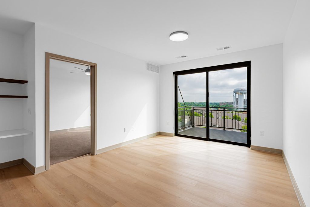 Living room with hardwood floors and sliding doors to balcony