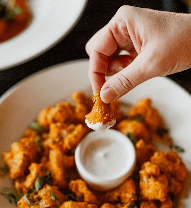 Plate of buffalo cauliflower bites with dipping sauce at a local Golden Valley restaurant
