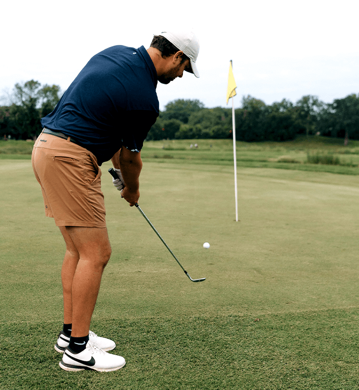 Golfer putting on a green at a Golden Valley golf course