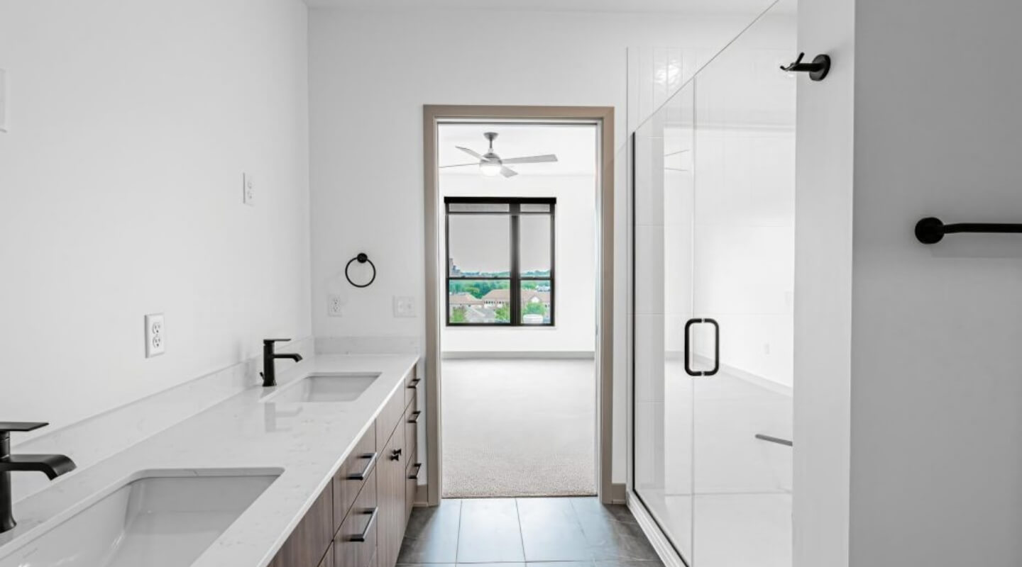 Spacious bathroom at The Winn at Golden Valley with double vanity and tile flooring