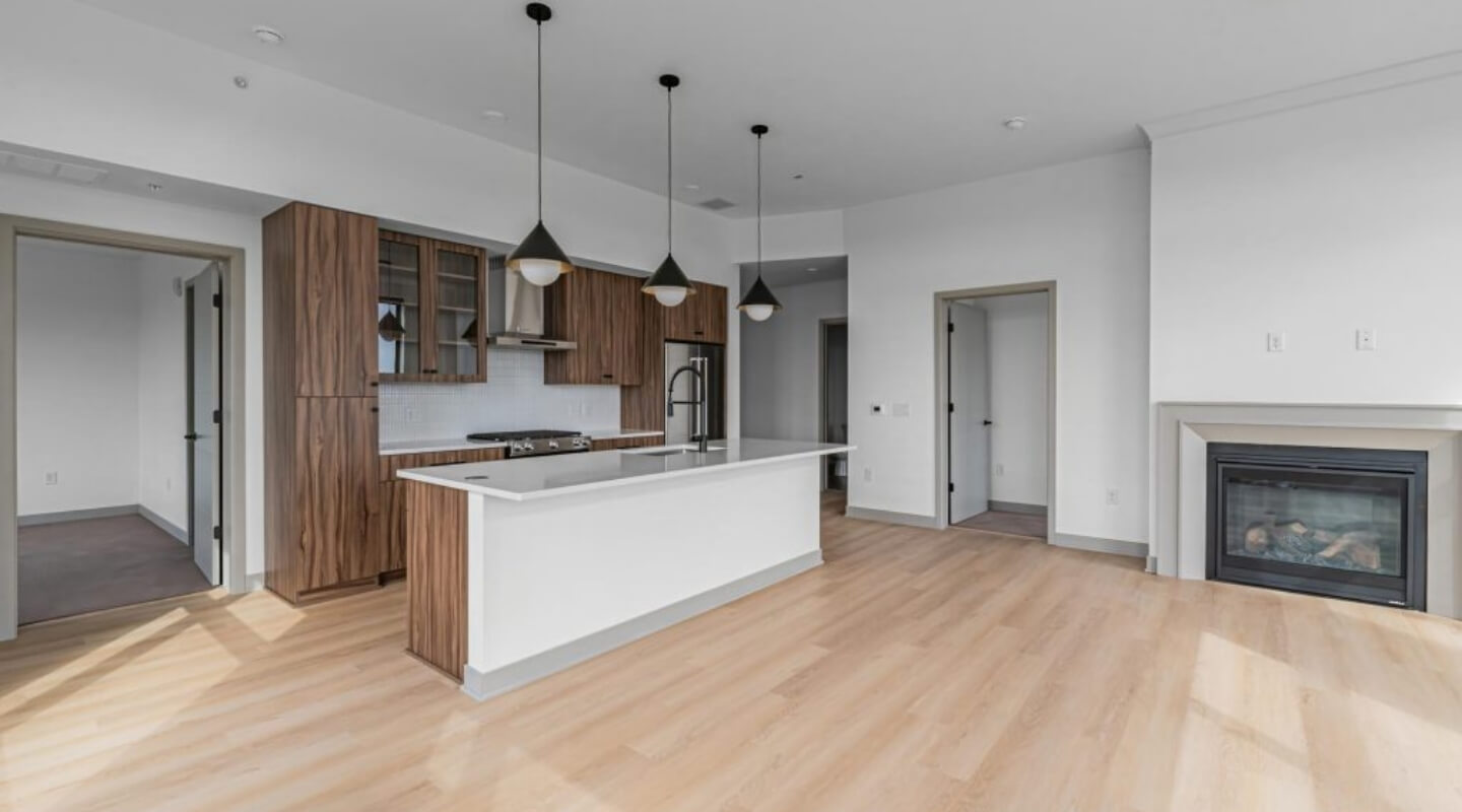 Open-concept kitchen and living area at The Winn at Golden Valley with island and fireplace