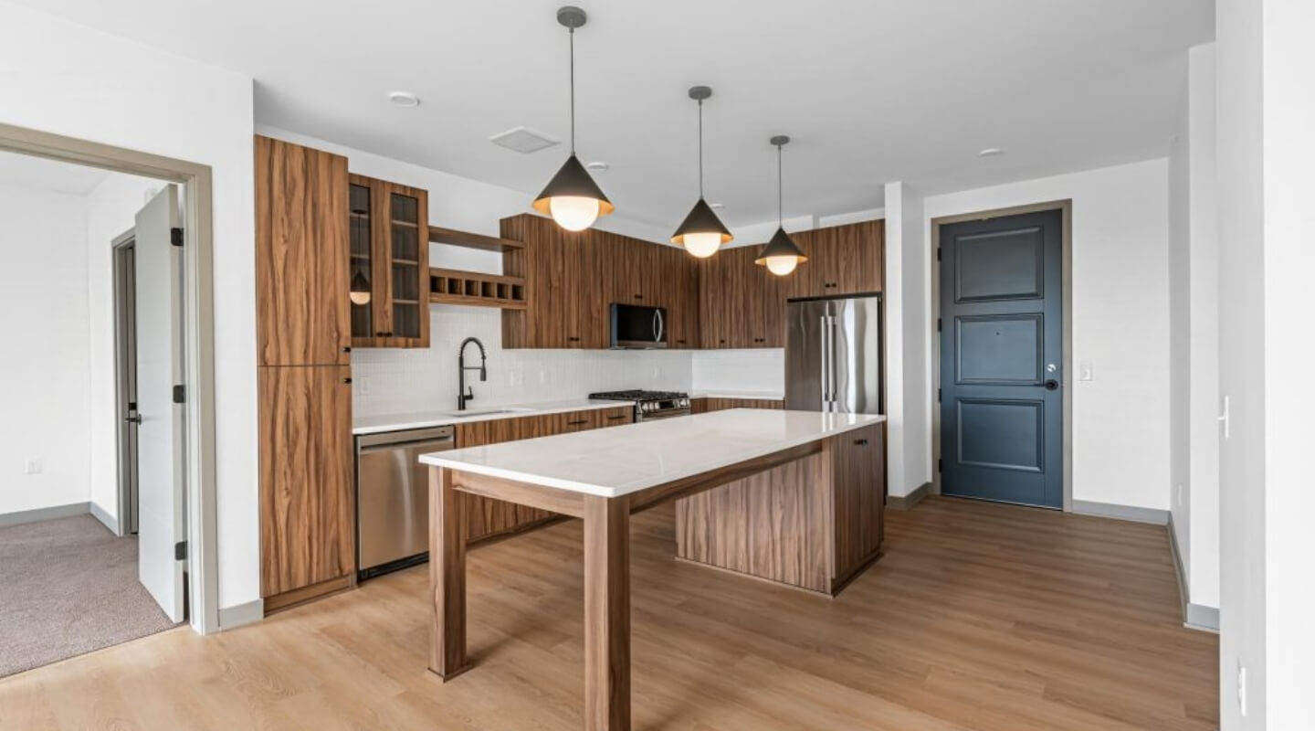 Kitchen at The Winn at Golden Valley with island, pendant lighting, and wood cabinetry