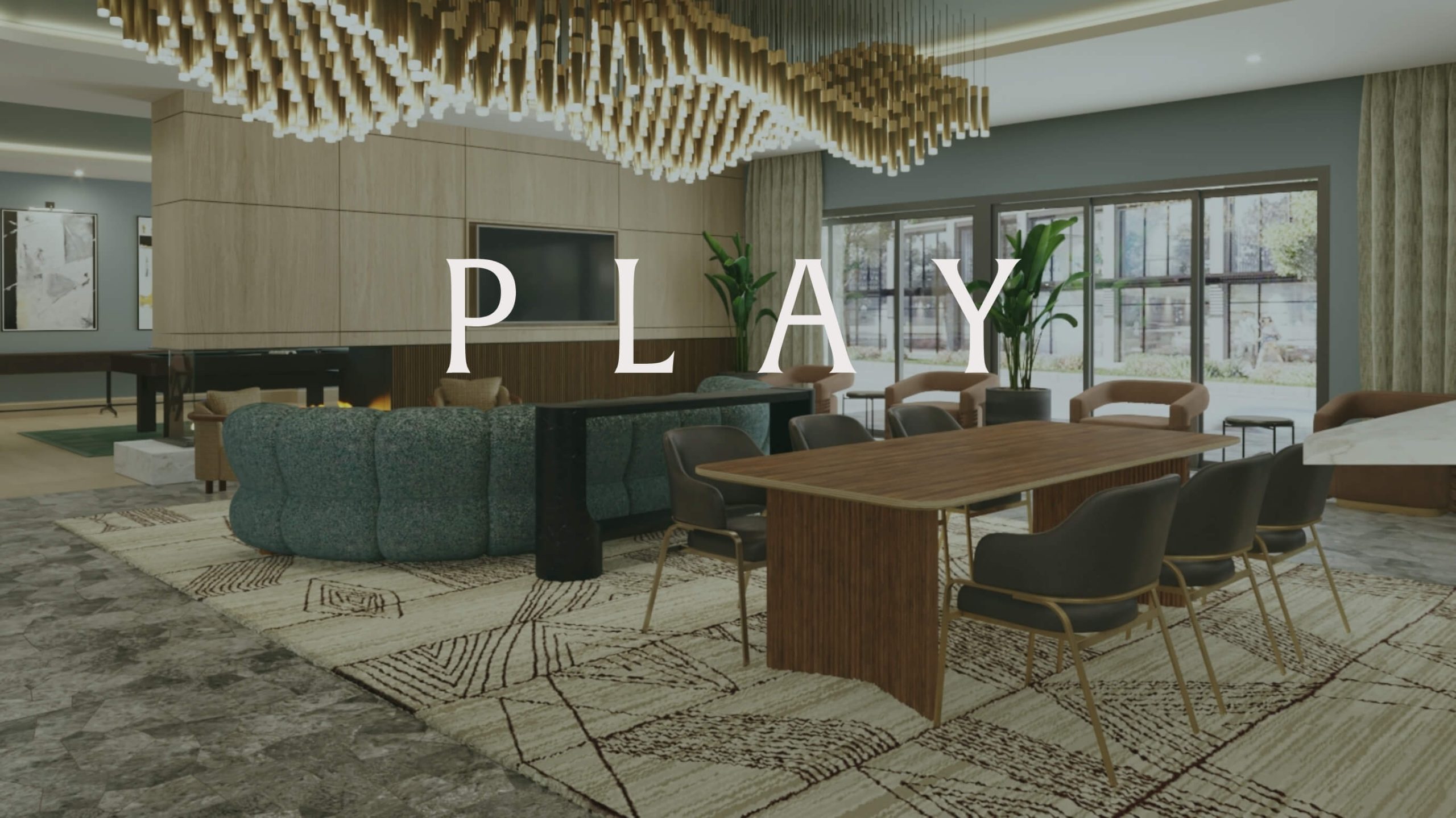 Apartment community lounge with table seating and chandelier featuring the word Play