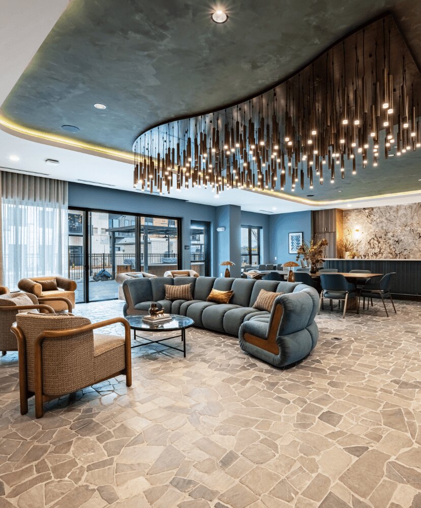 work lounge with beautiful lighting, couches and tables.