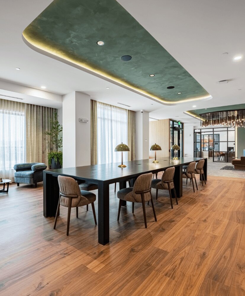 work from home suite with green ceiling fixtures, tables and chairs.